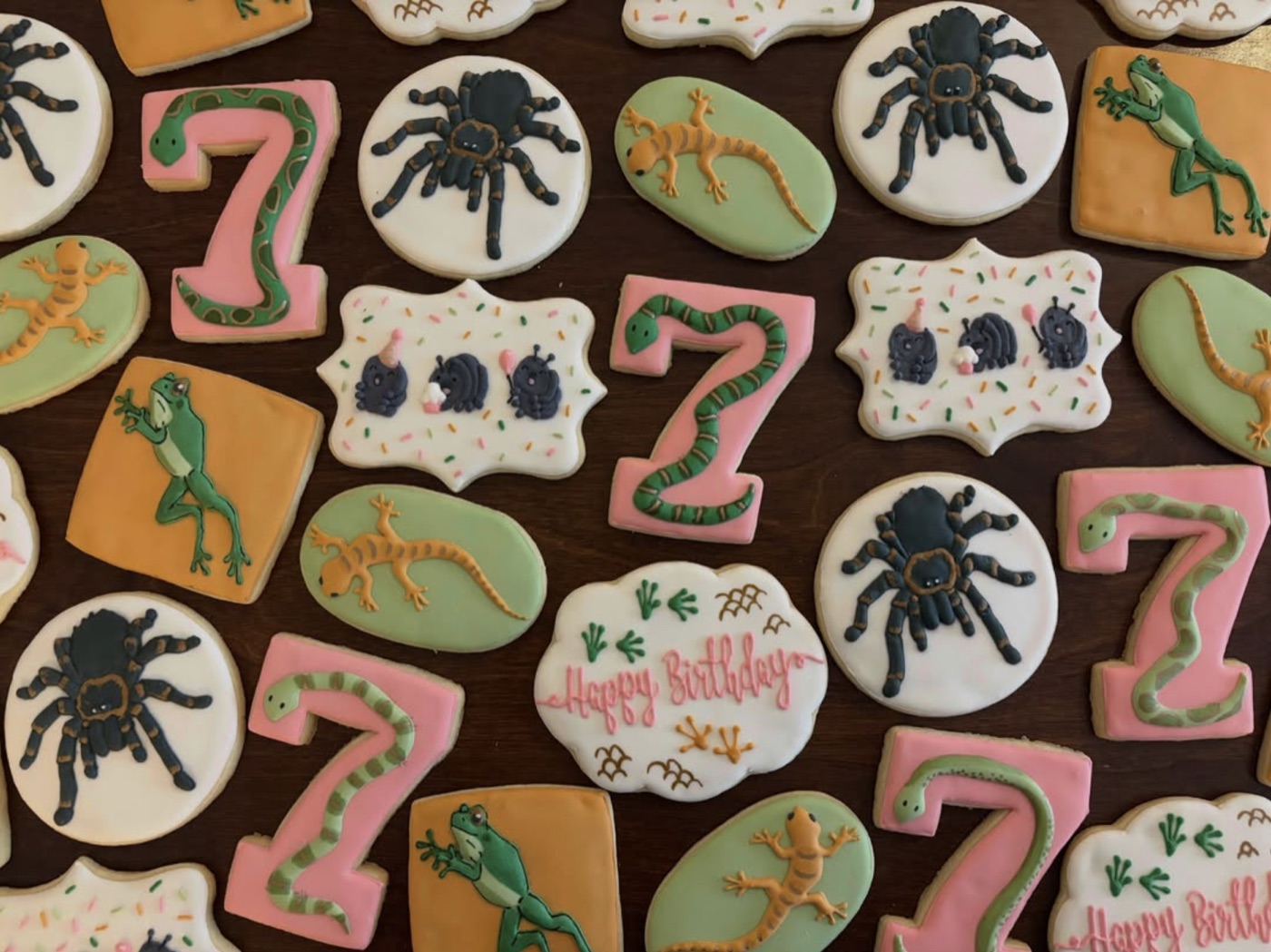 Playful seventh birthday cookies with snakes, spiders, frogs, and lizards