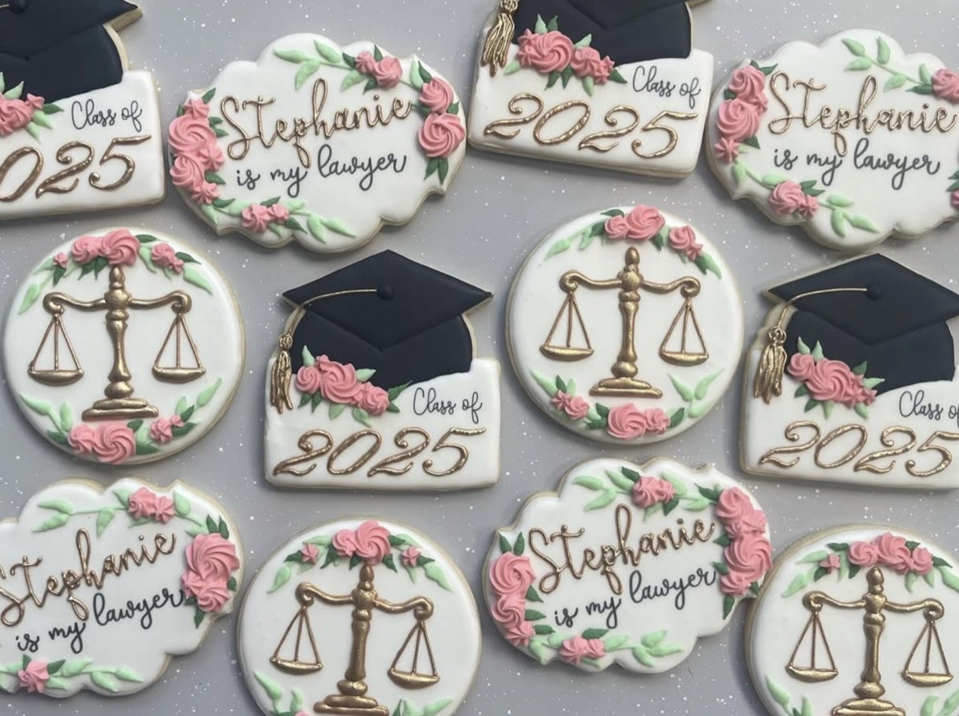 Graduation and law-themed cookies with pink flowers and gold details