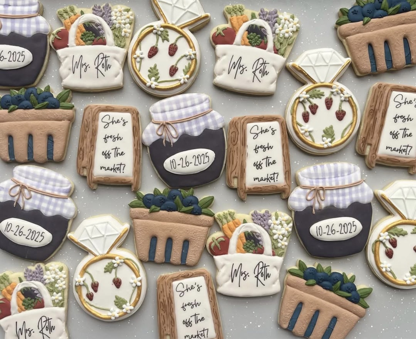 Farmers market-themed cookies with berries, baskets, jam, and florals